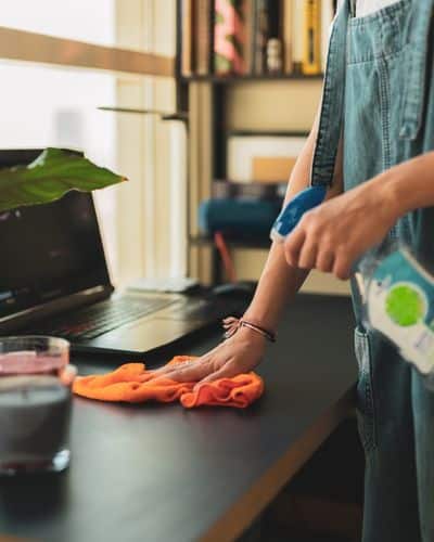 cleaner wiping office desk