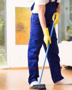 janitor sweeping floor in the office